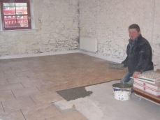 Andy tiling the floor of old stables
